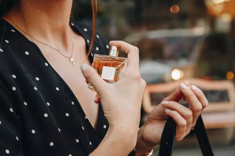 Cropped Model Holding Perfume Bottle Fragrance