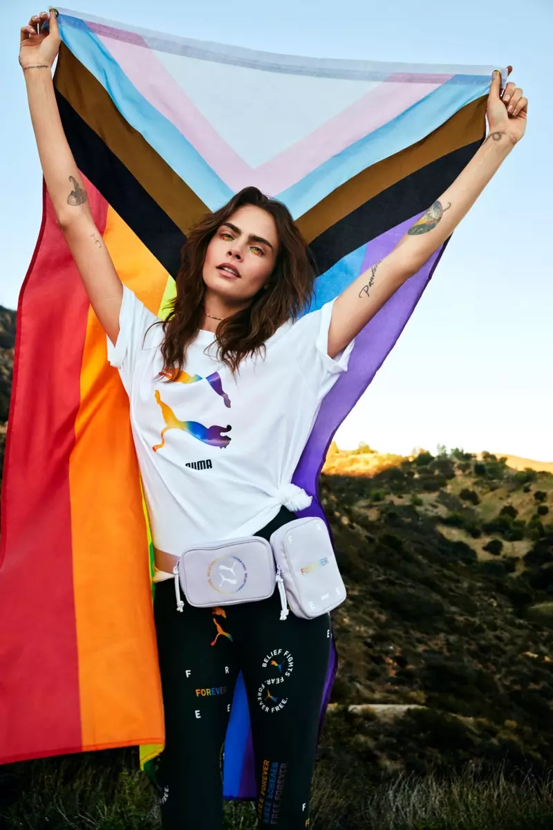 Cara Delevingne poserar med LBTQIA+-flaggan och leder kampanjen PUMA Pride 2021.