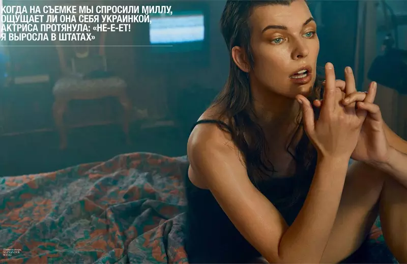 Milla Jovovich, pózující na posteli, má na sobě šaty Alexandra Wanga