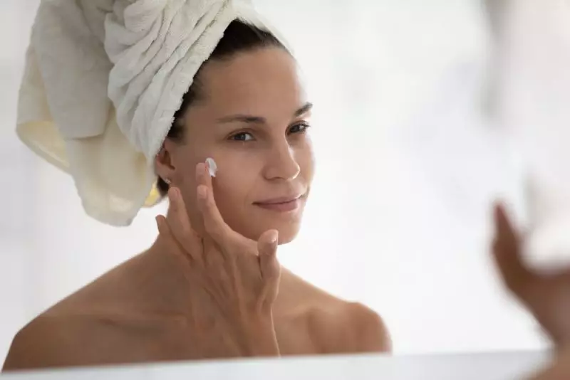 Woman Moisturizing Face