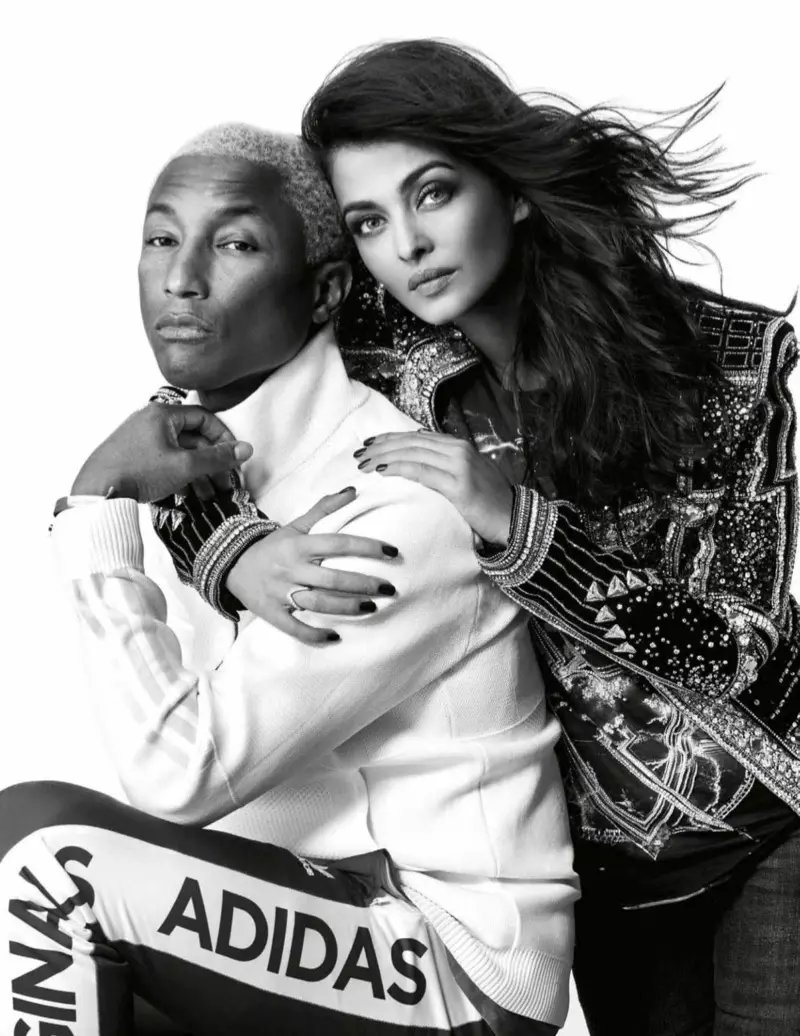 Aishwarya Rai, sem er tekin í svörtu og hvítu, klæðist Balmain stuttermabol og jakka með Zara gallabuxum ásamt Pharrell Williams