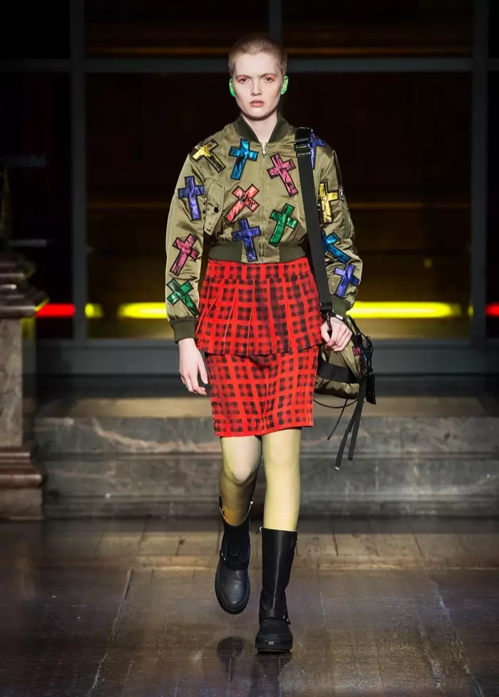 RAD IN PLAID: რუთ ბელი დადის ასაფრენ ბილიკზე Moschino-ს 2016 წლის შემოდგომა-ზამთრის ჩვენებაზე, აცვია შარვალი ქვედაკაბა და ჯვრით მორთული ბომბდამშენის ქურთუკი საბრძოლო ჩექმებით