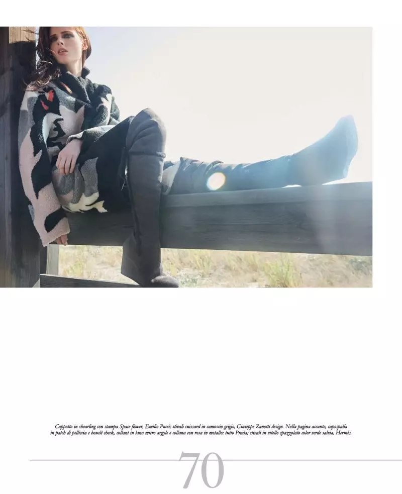 Coco Rocha sidder på et hegn og modellerer Emilio Pucci shearling cape med Giuseppe Zanotti Design støvler