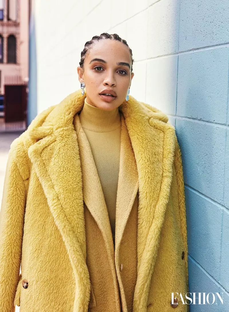 Cleopatra Coleman sjocht mellow yn giel, draacht Max Mara-jas, jas en coltrui mei Jenny Bird-earringen